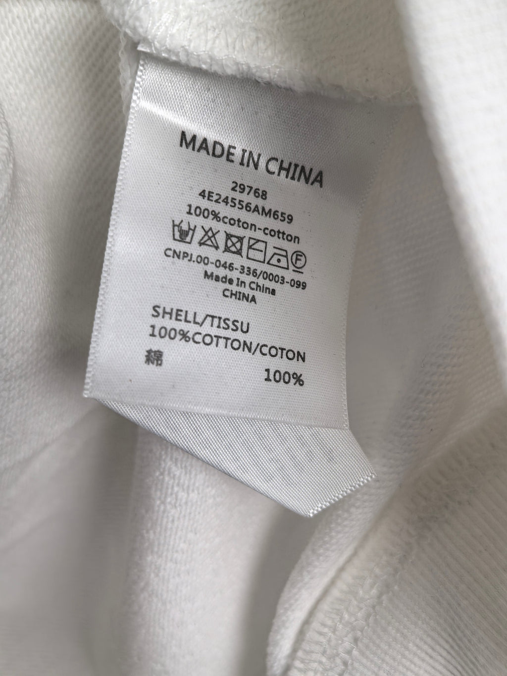 Inside neck label: Made in China; 100% cotton; care instructions