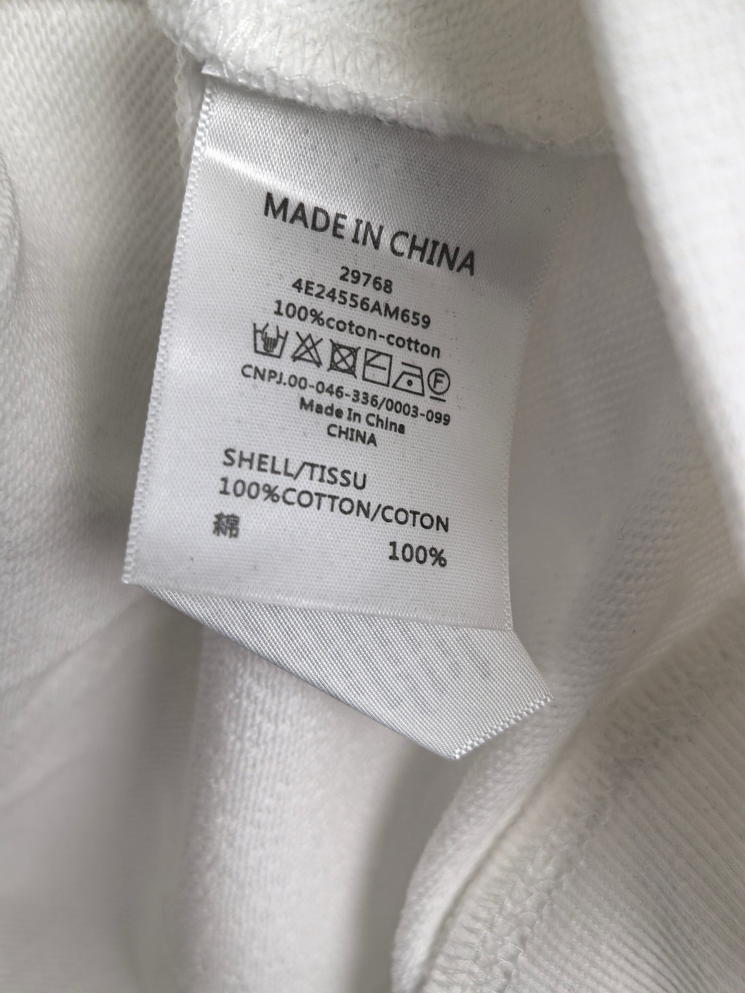 Inside neck label: Made in China; 100% cotton; care instructions