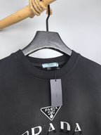 Prada crewneck sweatshirt neckline with attached size tag and logo