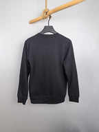 Dark gray long-sleeve sweatshirt, back view on hanger