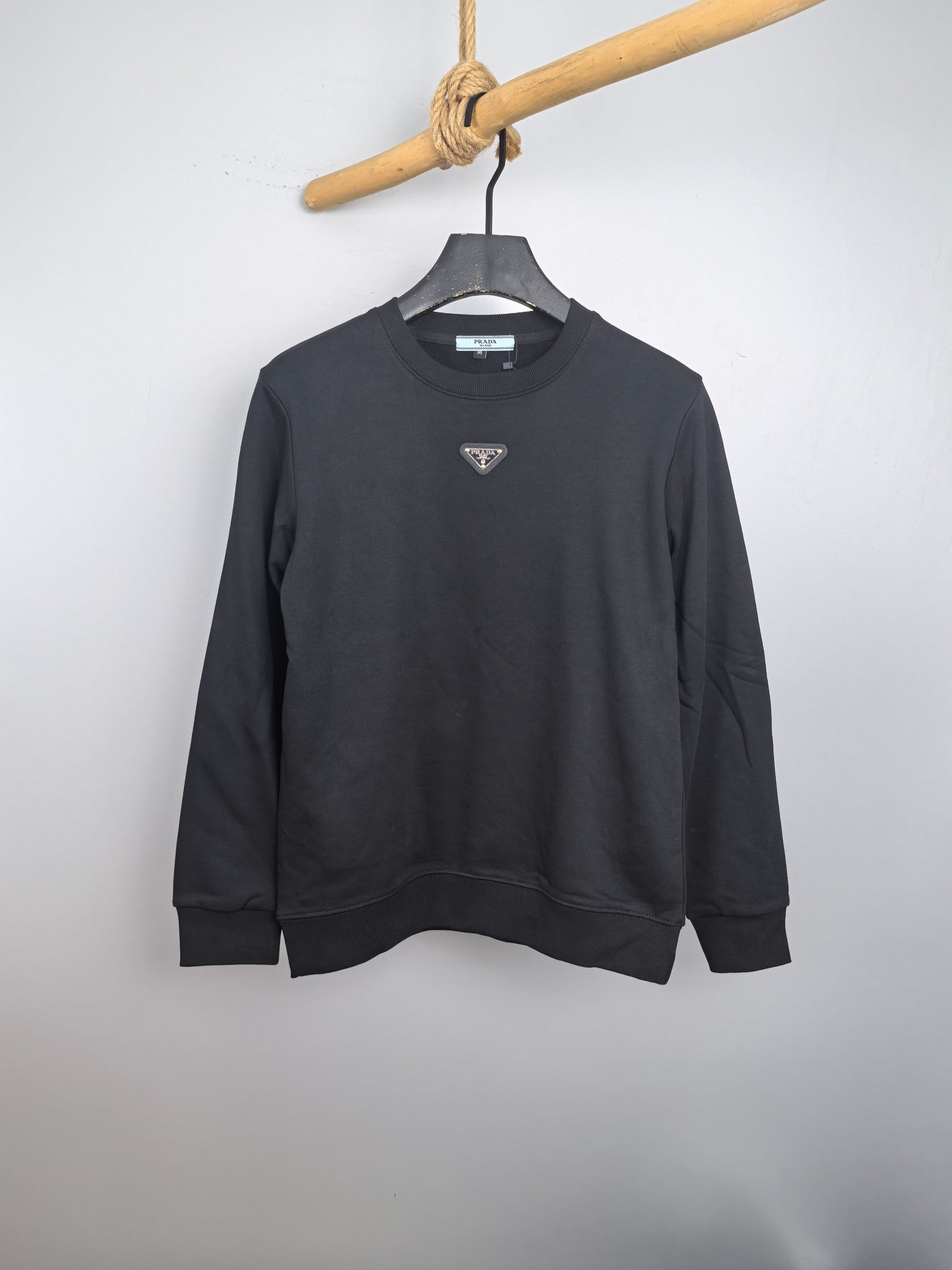 Dark gray long-sleeve sweatshirt with small triangular Prada logo on chest