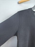 Dark gray long-sleeve sweatshirt sleeve and shoulder seam detail