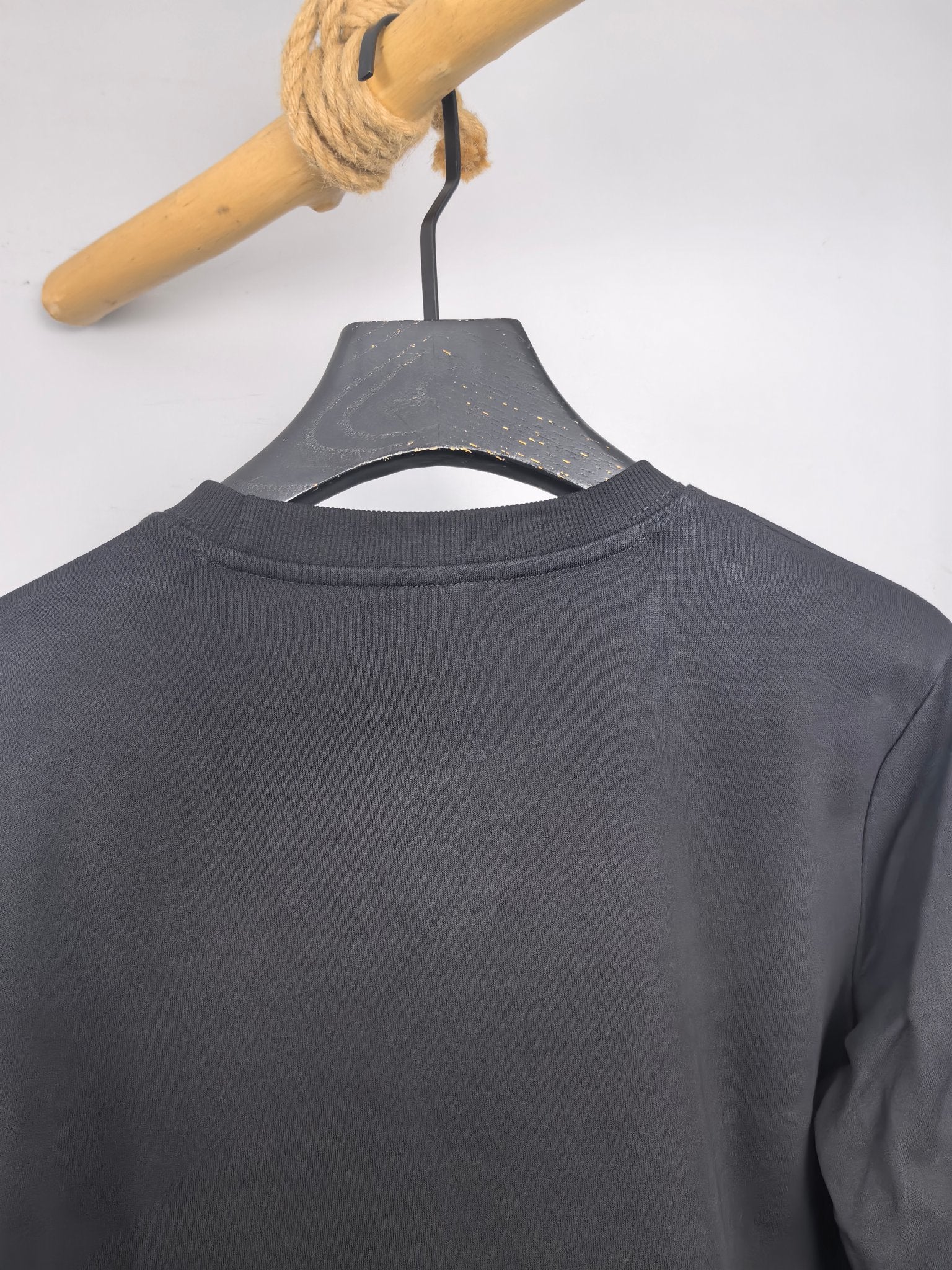 Dark gray sweatshirt back neck with crew collar seam
