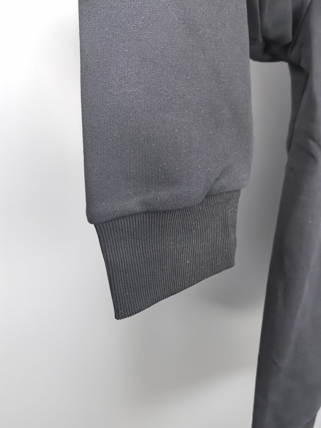 Dark gray sweatshirt hem with ribbed cuff detail