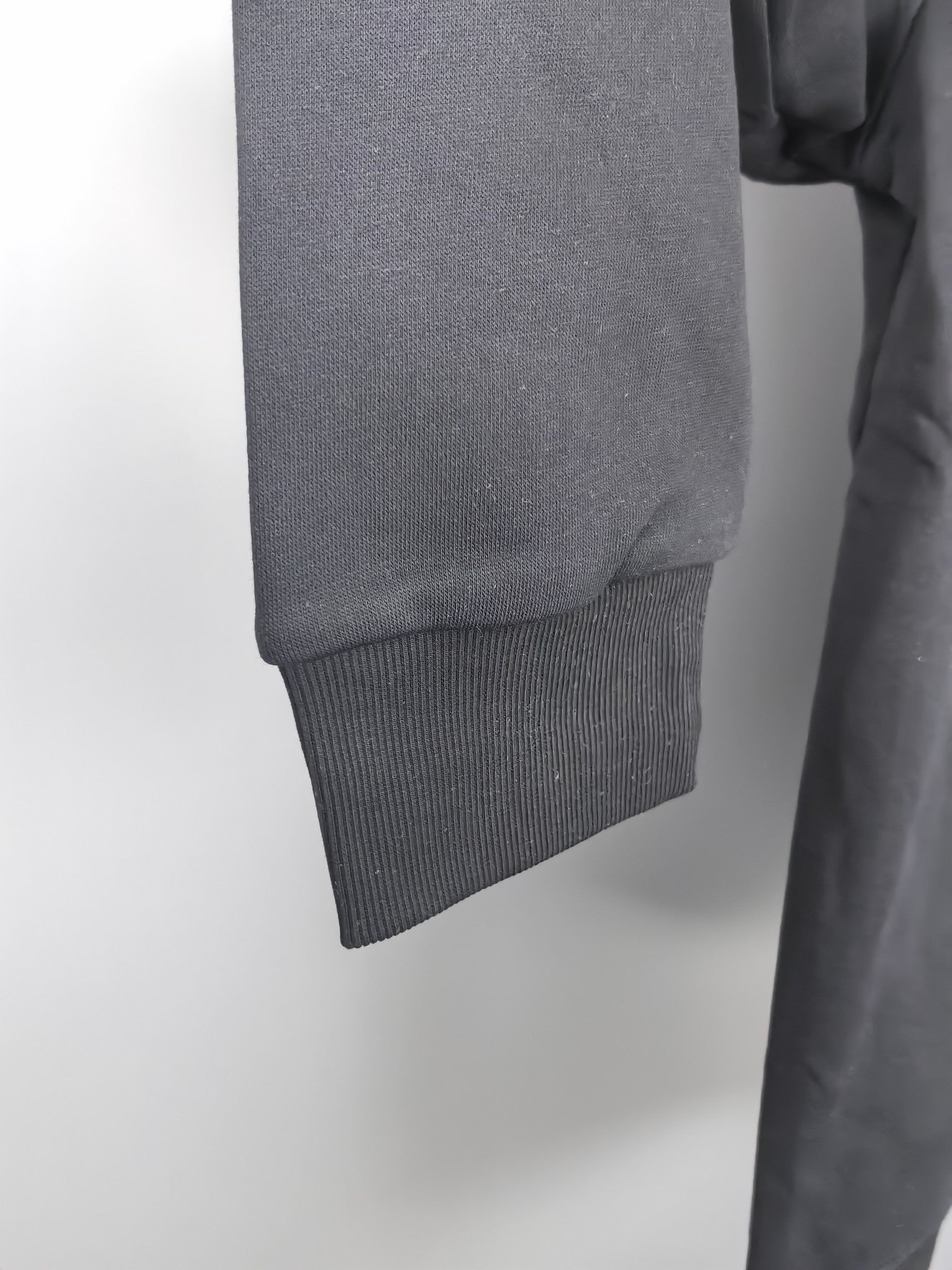 Dark gray sweatshirt hem with ribbed cuff detail