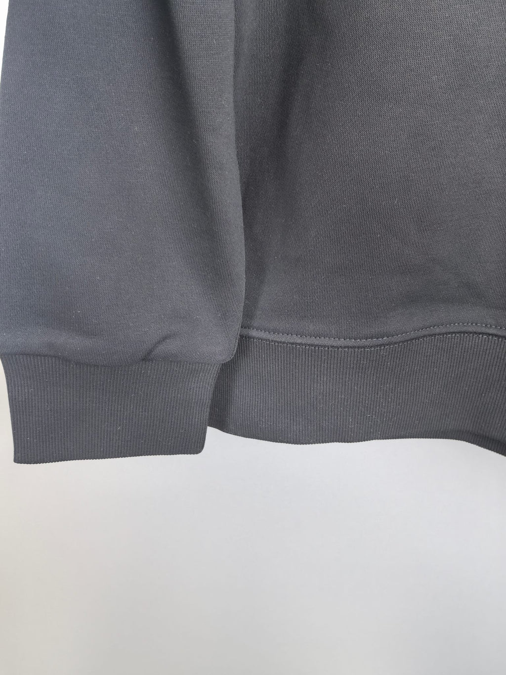 Dark gray sweatshirt hem ribbing detail