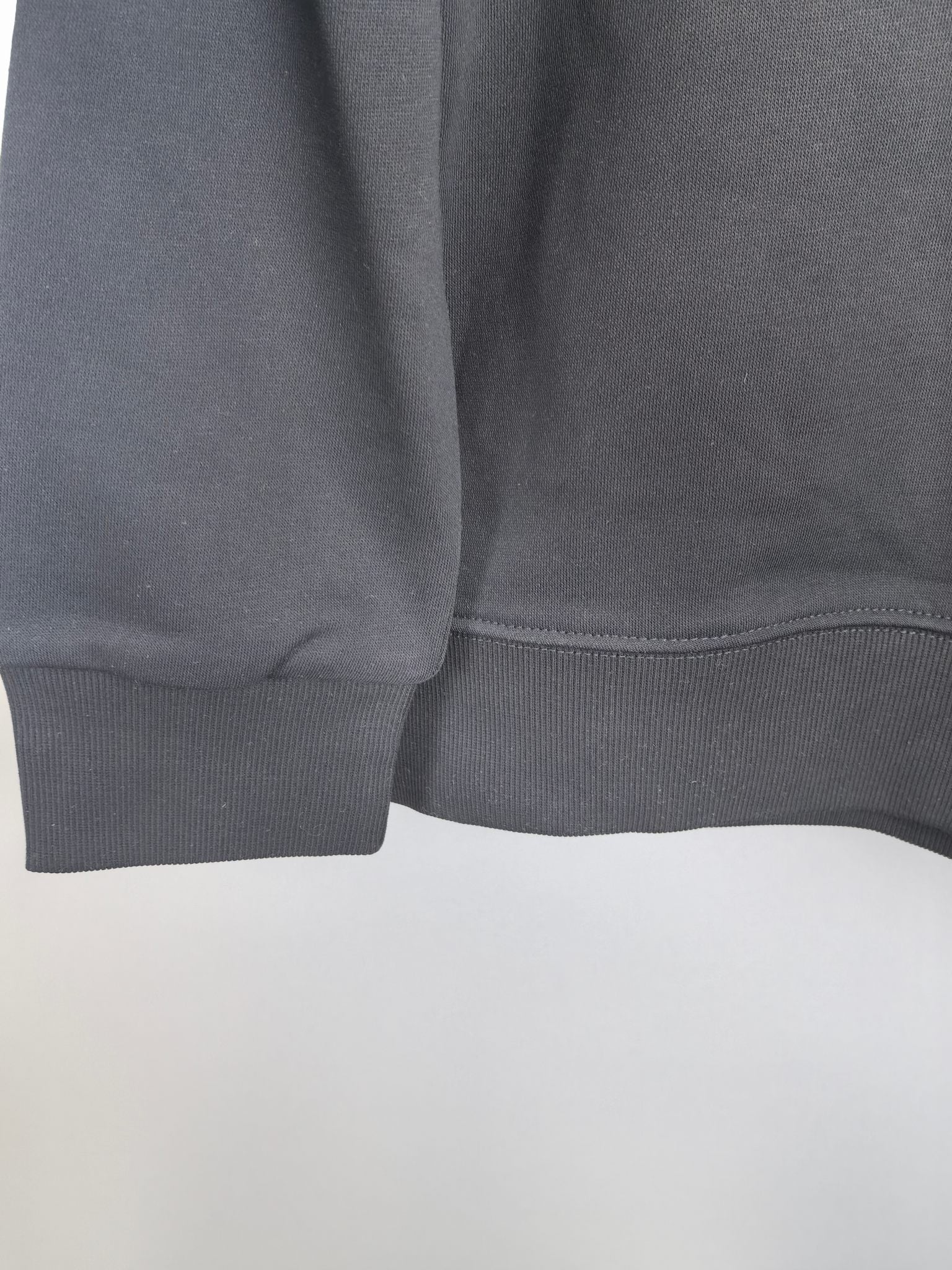 Dark gray sweatshirt hem ribbing detail
