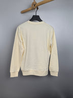 Cream long-sleeve sweatshirt, back view on hanger