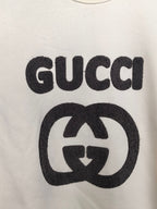 Cream sweatshirt front with large black GUCCI and GG emblem graphic