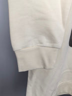 Cream sweatshirt hem and ribbed cuffs, plain fabric on hanger