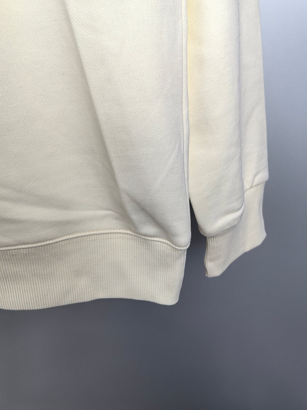 Cream sweatshirt back hem with ribbed waistband and sleeve cuff
