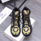 Black high-top sneakers with gold Medusa emblem on toe and lace-up front styling