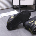 Side view of black high-top sneaker outsole with textured tread and patterned upper