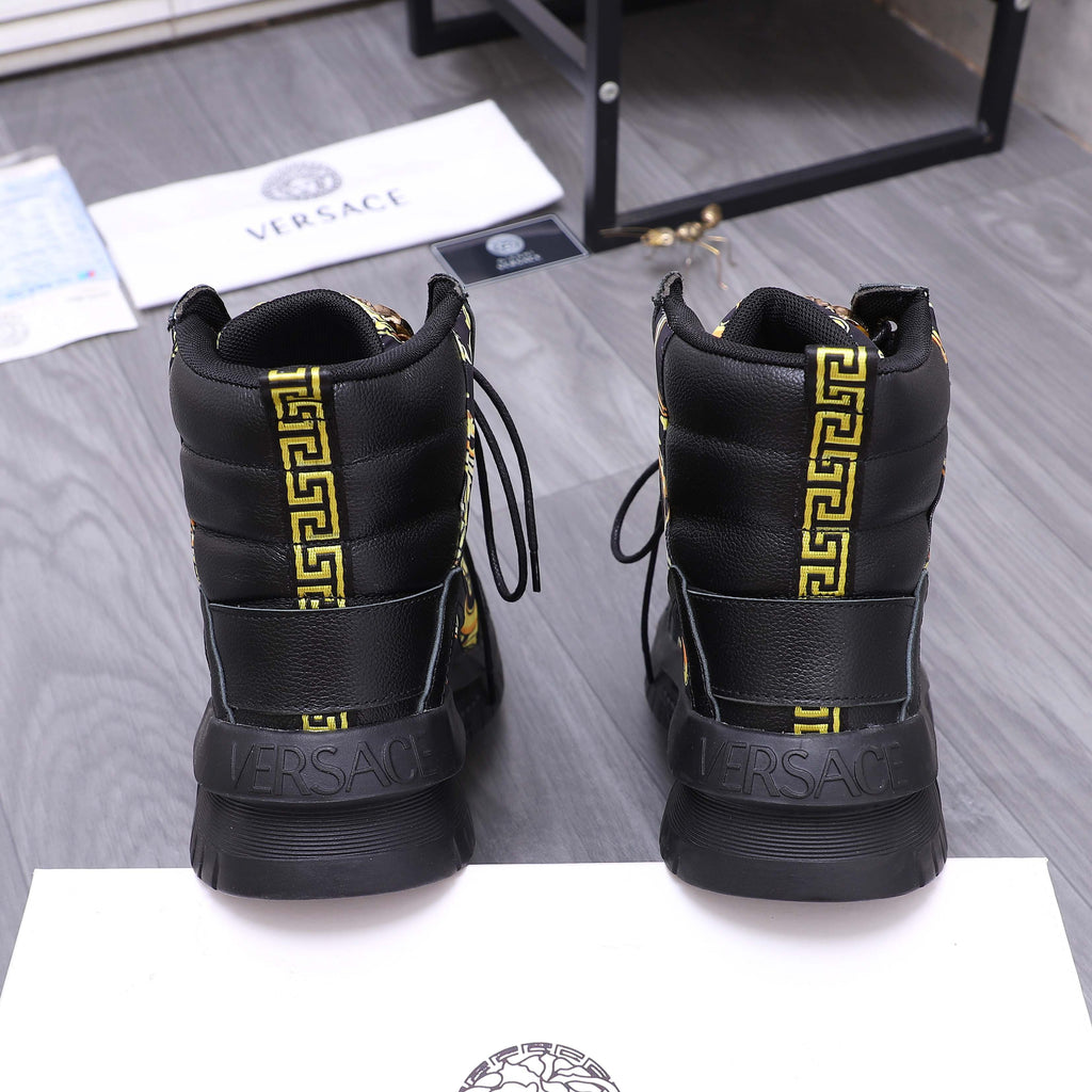 Back view of black high-top sneakers with gold Greek key stripe and Versace heel logo
