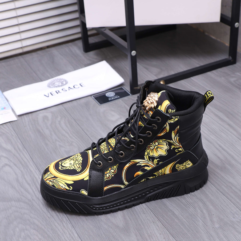 Black high-top sneakers with gold medallion print and lace-up front on a platform sole