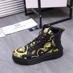 Black high-top sneakers with gold medallion print and lace-up front on a platform sole