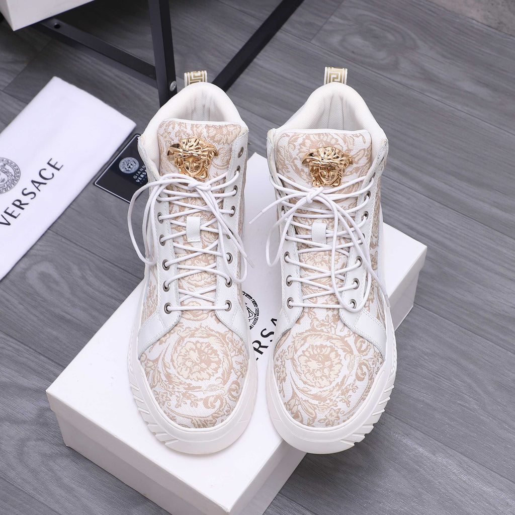 White high-top sneakers with gold-toned medallion, lace-up and patterned panels