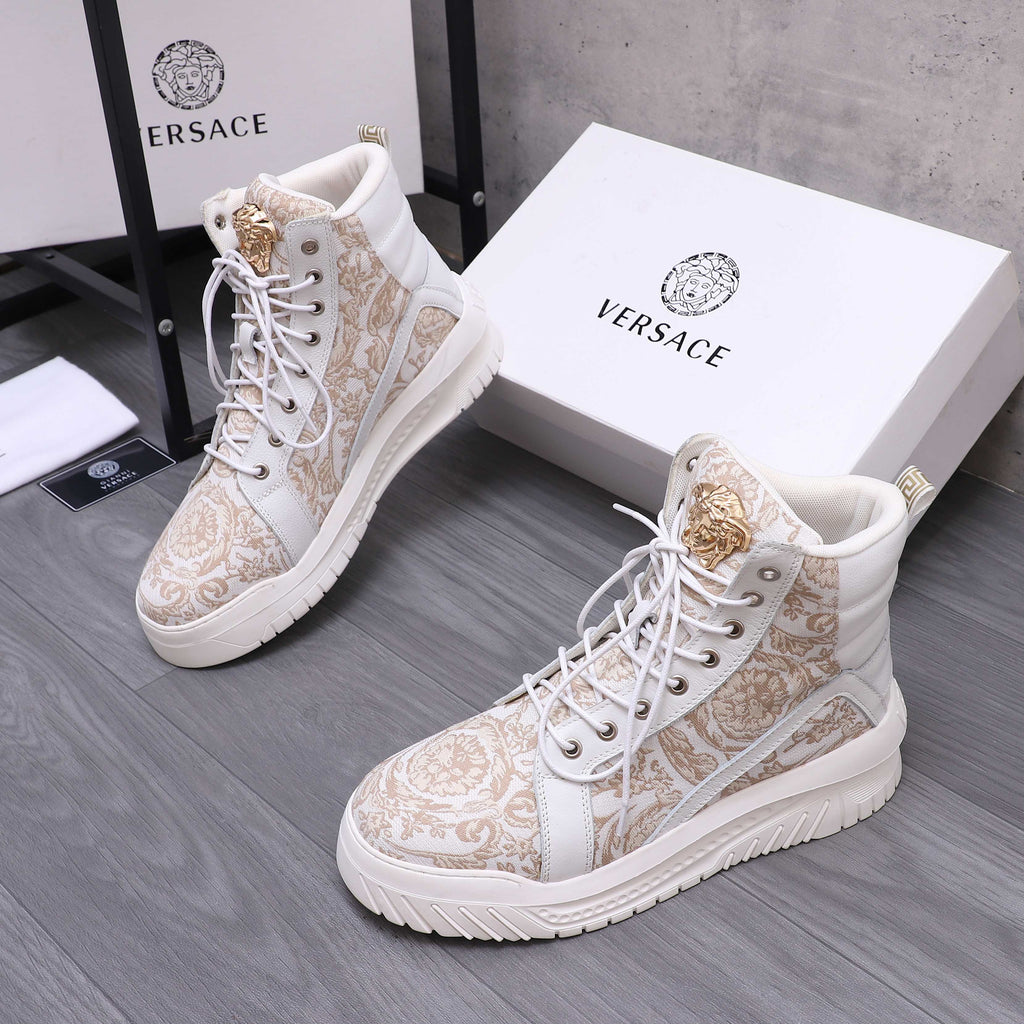 White high-top sneakers with ornate gold pattern, lace-up and gold heel emblem