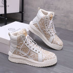 White and gold patterned high-top sneakers with gold emblem on tongue
