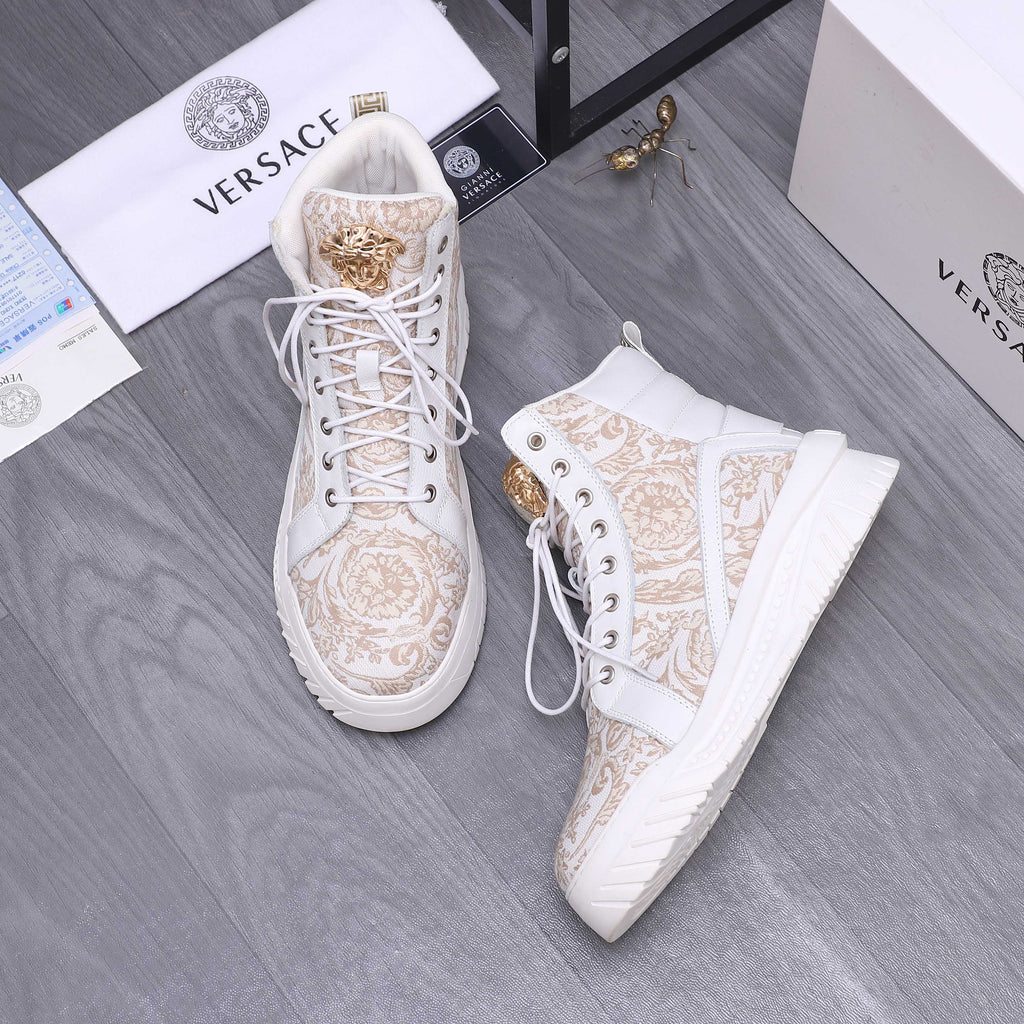 White high-top sneakers with gold pattern, lace-up front and gold eyelet accents