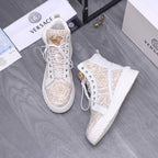 White high-top sneakers with gold pattern, lace-up front and gold eyelet accents