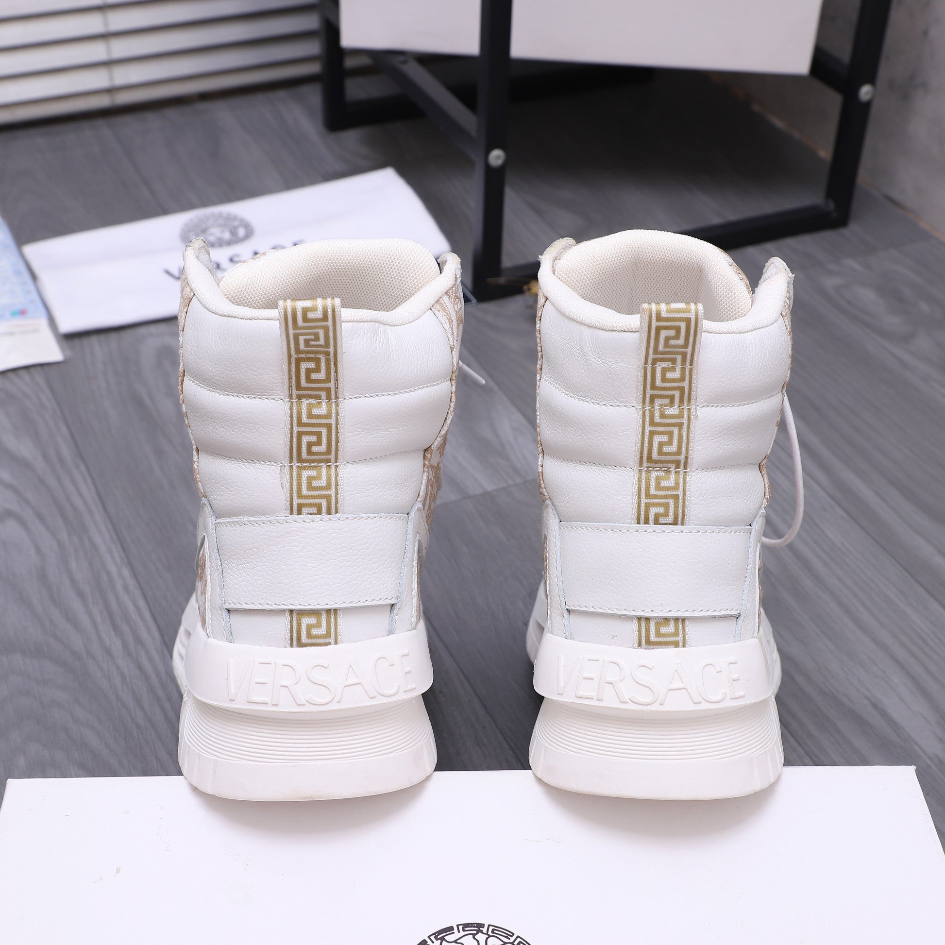White high-top sneakers with gold accent strap and cushioned ankle collar