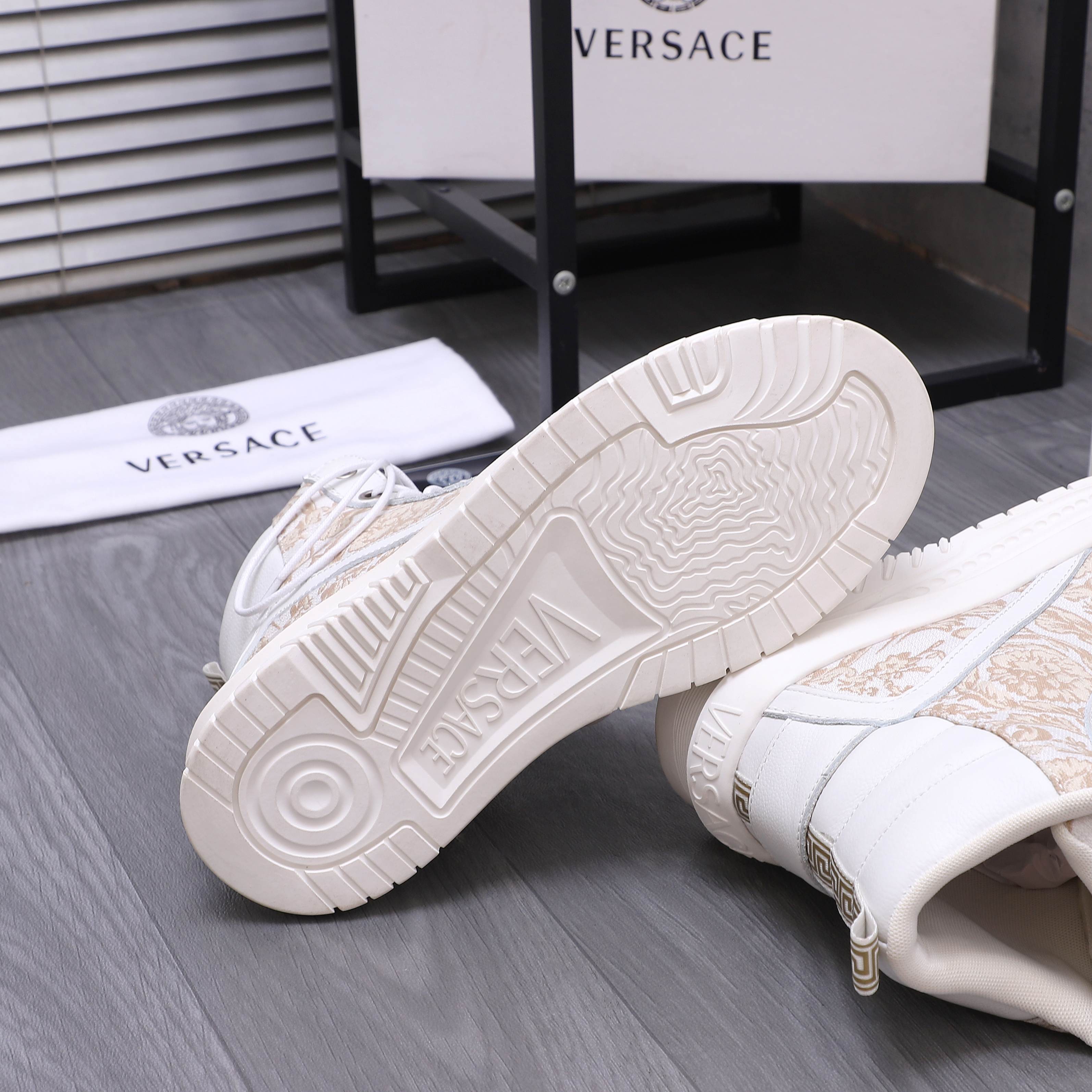 White high-top sneaker outsoles with deep tread, side logo details