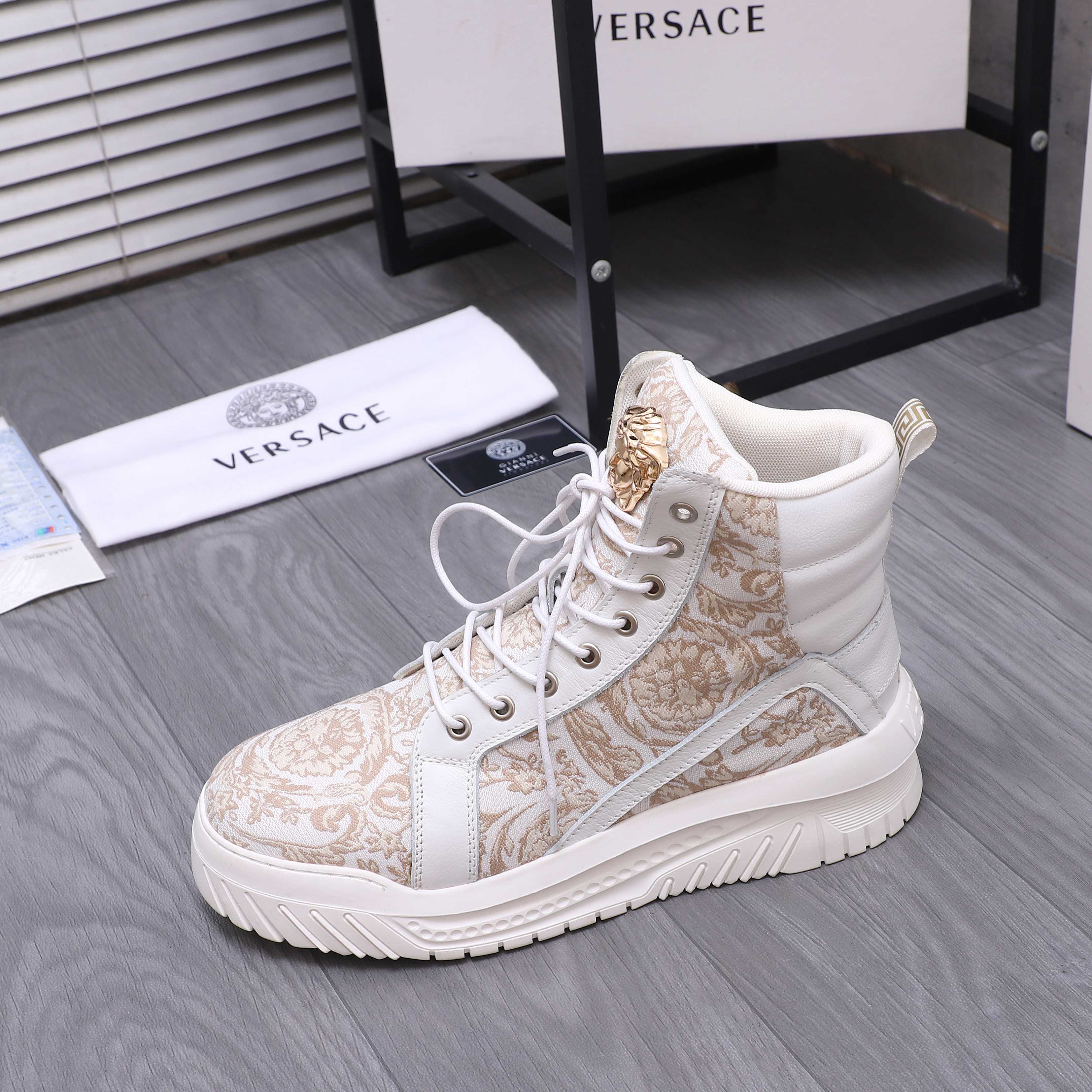 White high-top sneakers with gold patterned quarter panels and lace-up closure