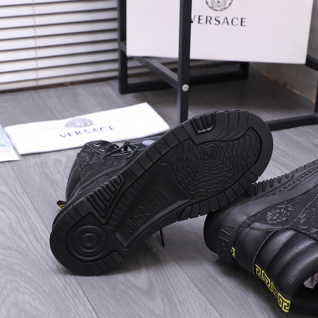 Versace black high-top sneaker outsole with chunky tread and embossed logo detail