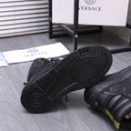 Versace black high-top sneaker outsole with chunky tread and embossed logo detail