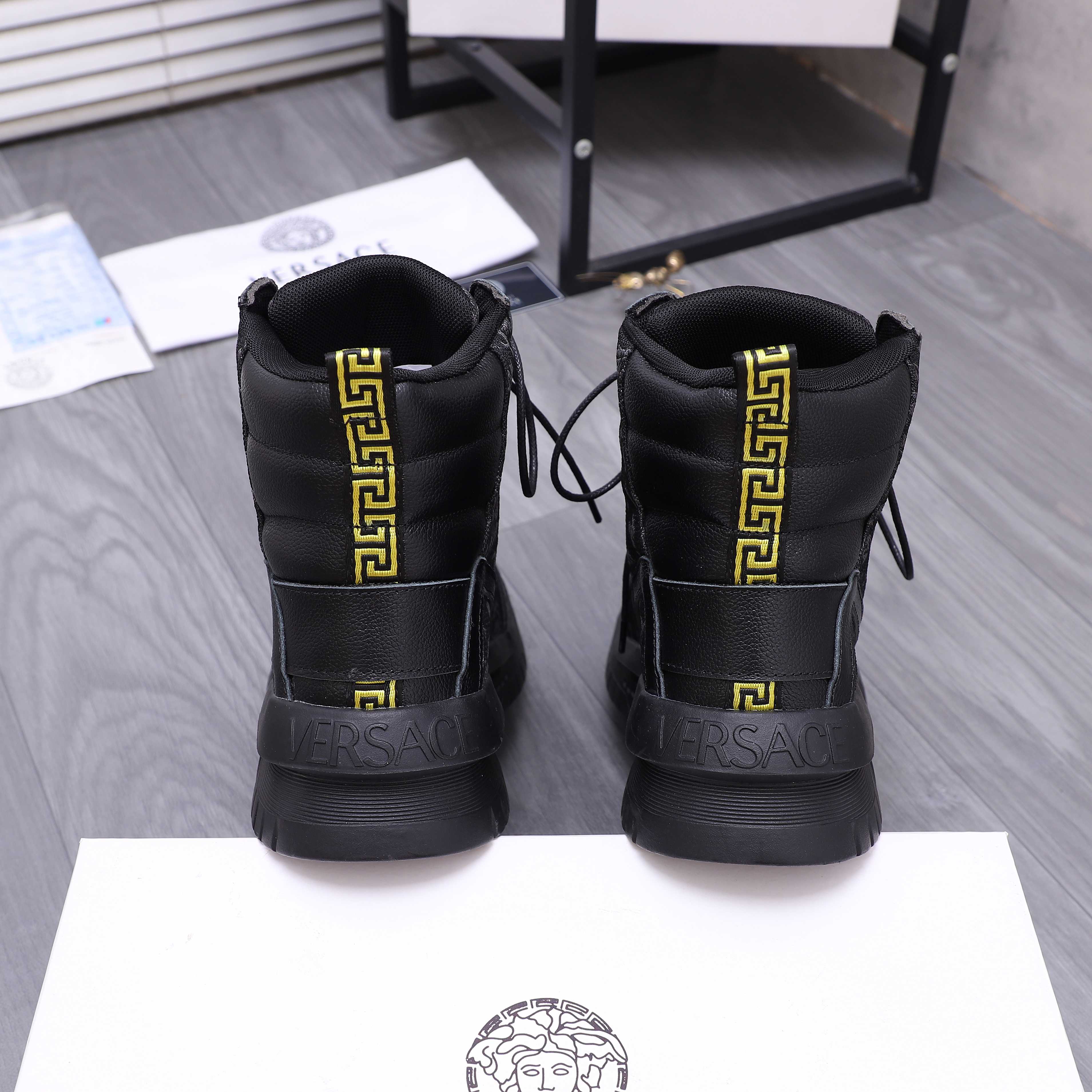 Versace black high-top sneakers with rear gold logo plaque and lace-up closure