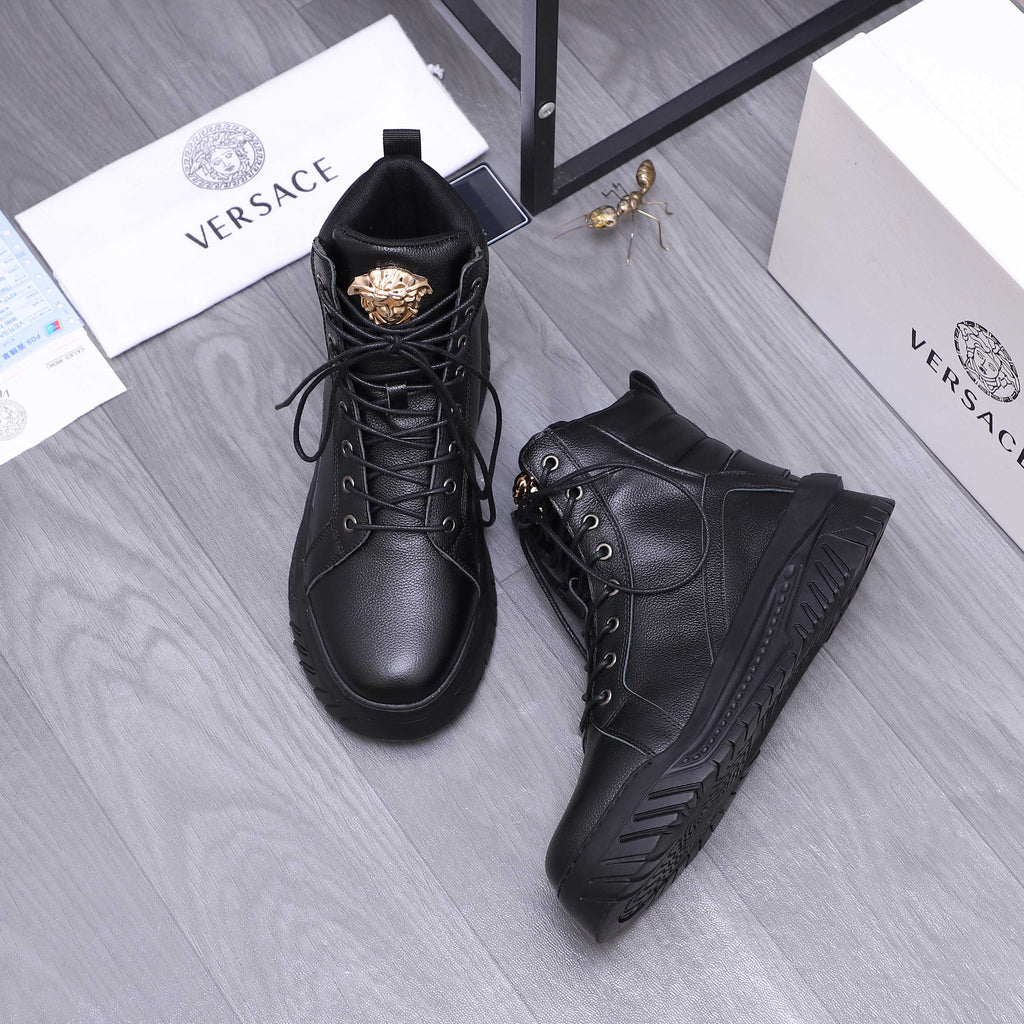 Black lace-up high-top shoes with gold emblem on tongue and side panel stitching