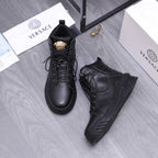 Black lace-up high-top shoes with gold emblem on tongue and side panel stitching