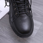 Close-up of black leather lace-up high-top shoe upper with metal eyelets