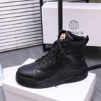 Black lace-up high-top sneaker boots with gold emblem on tongue and textured outsole