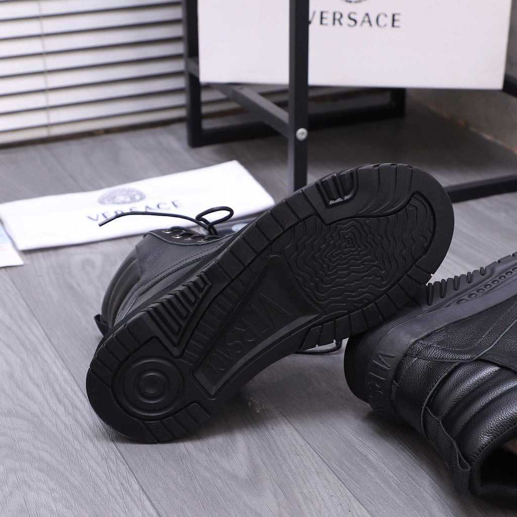 Black shoe outsoles with deep tread pattern on thick rubber soles