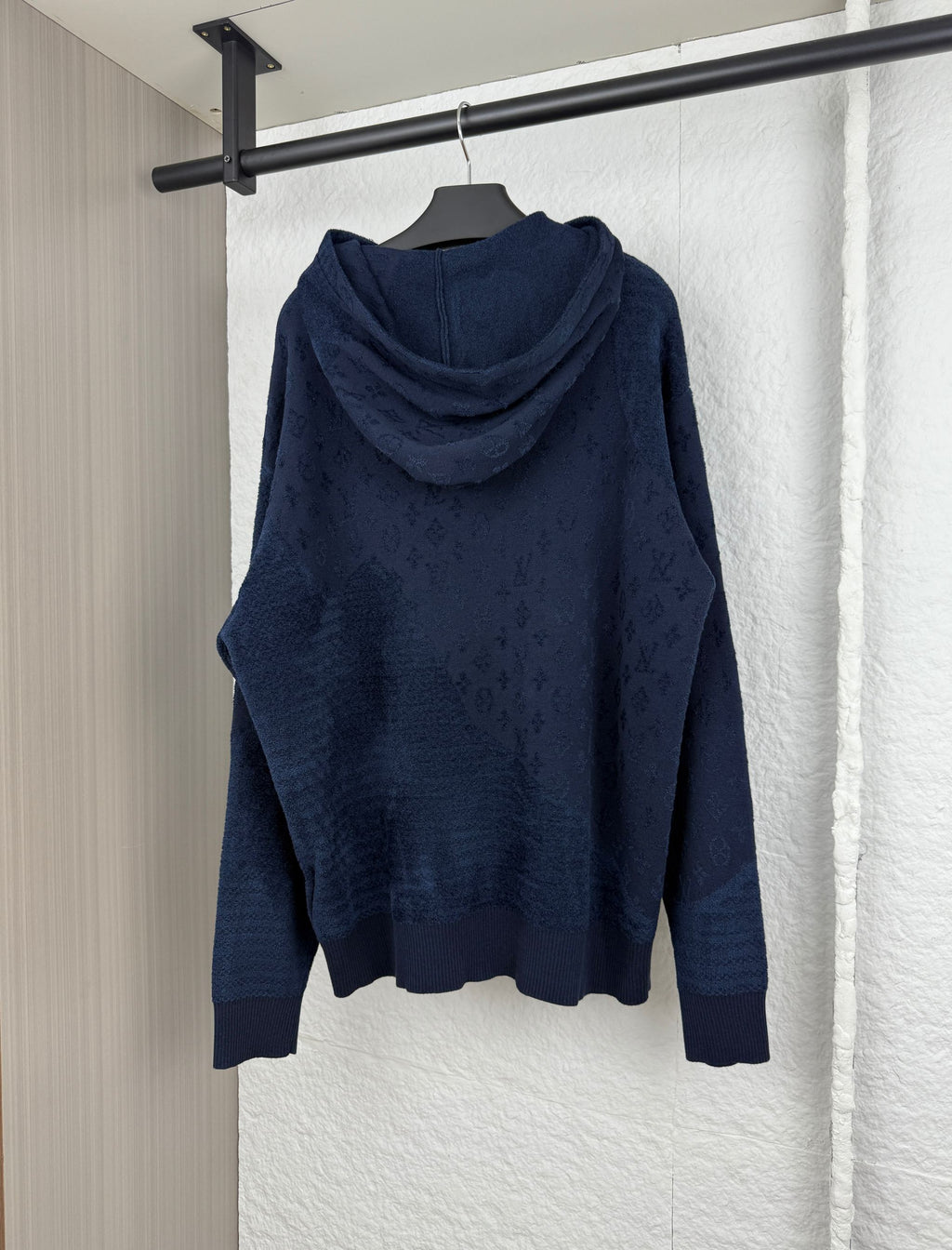 Dark blue monogram hooded sweatshirt, ribbed cuffs and hem, back view.