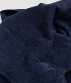 Dark blue monogram fabric with hood fold, close-up.