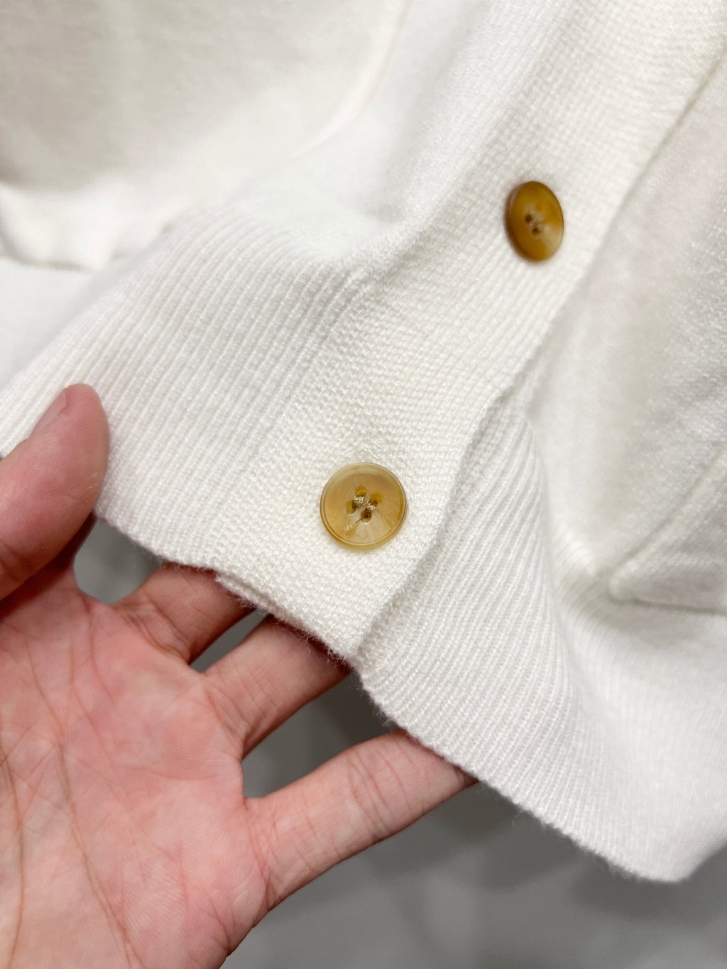 Dior white cardigan sleeve cuff with ribbed knit edge and gold button