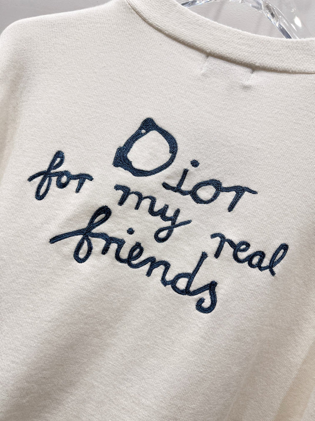 Dior white graphic text 'for my real friends' with blue script and heart icon