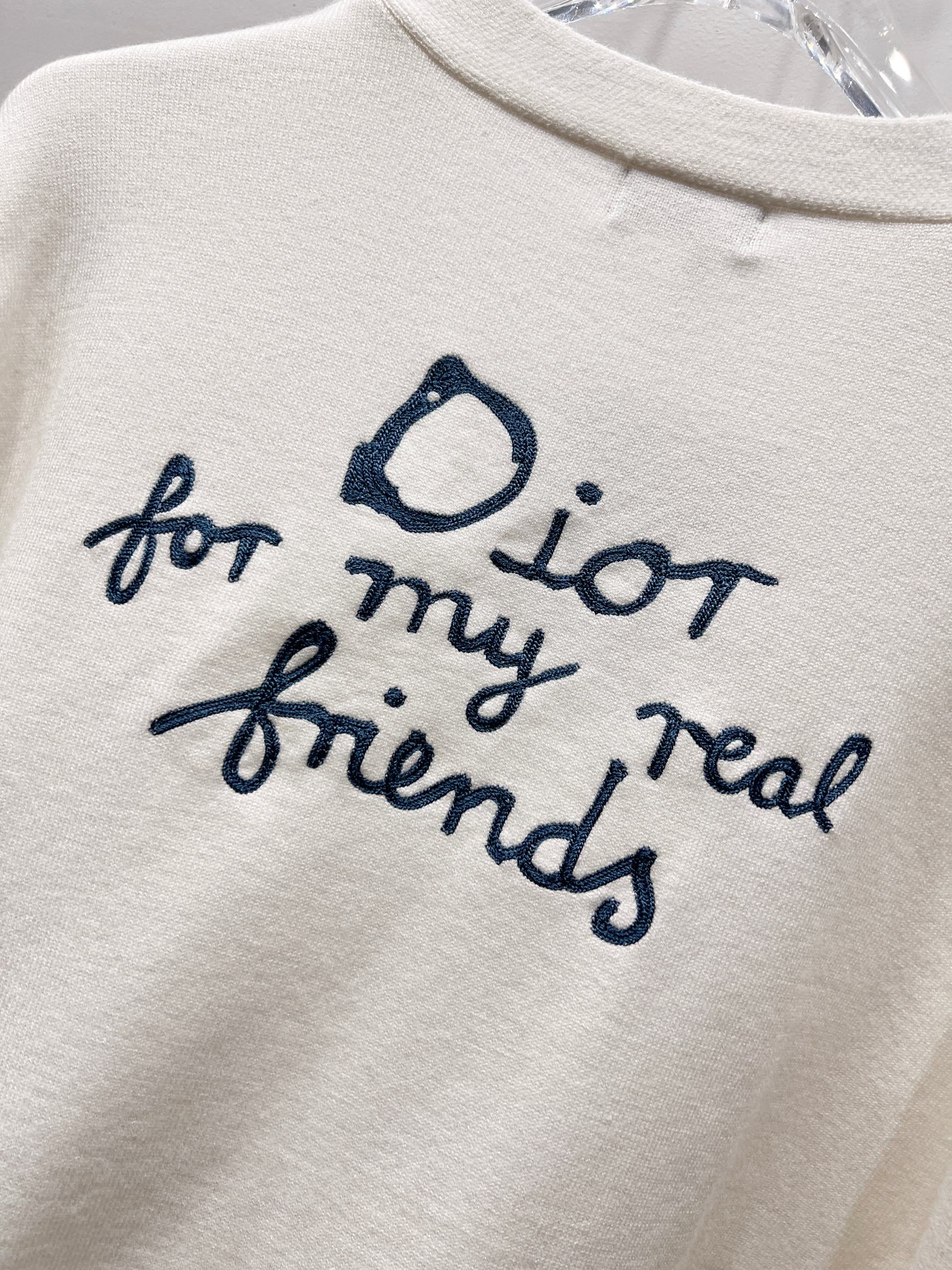 Dior white graphic text 'for my real friends' with blue script and heart icon