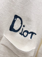 Dior white cardigan front pocket area with blue 'Dior' logo