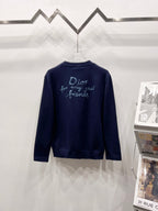 Navy V-neck cardigan with turquoise back embroidery text and script
