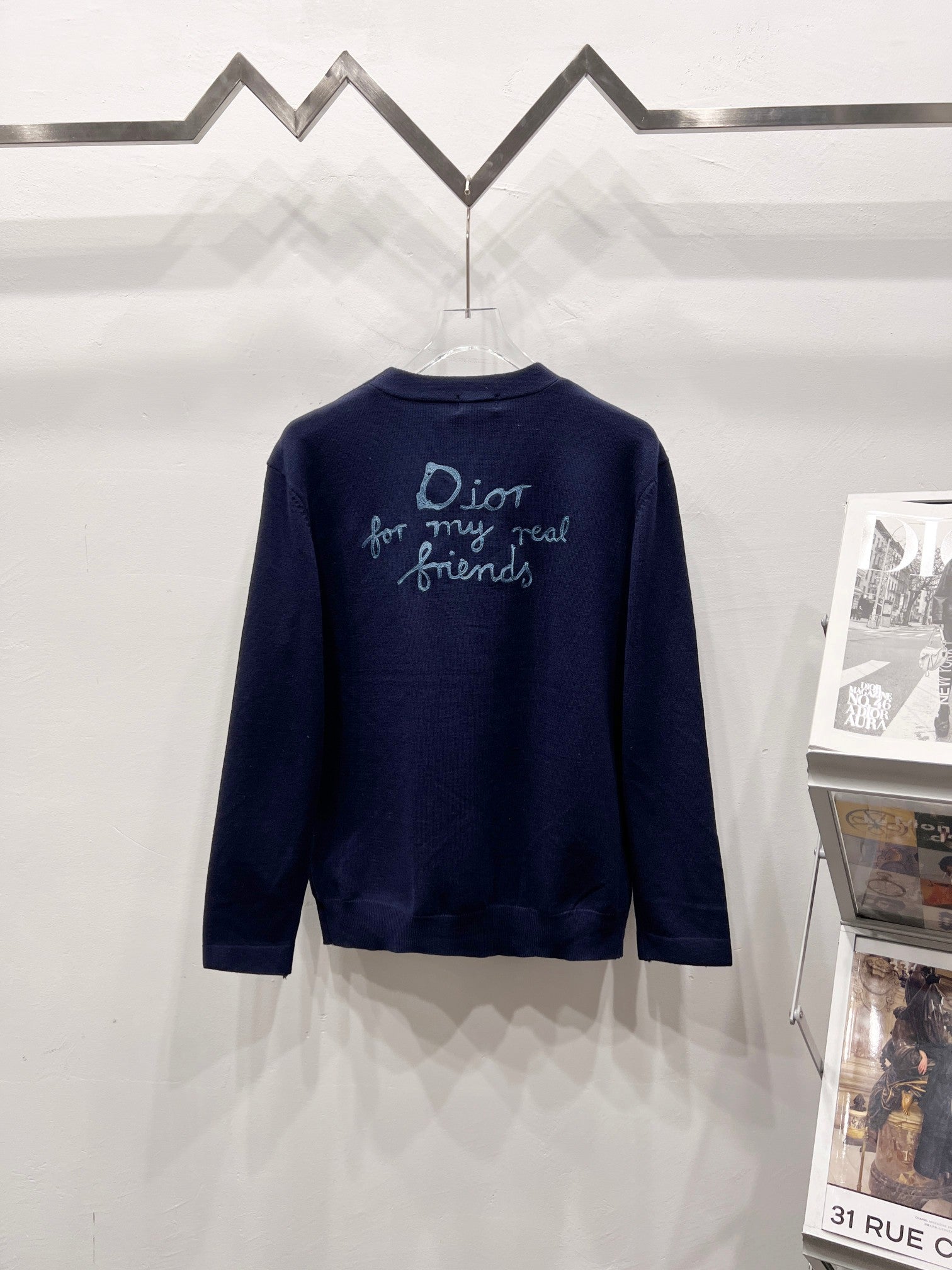 Navy V-neck cardigan with turquoise back embroidery text and script