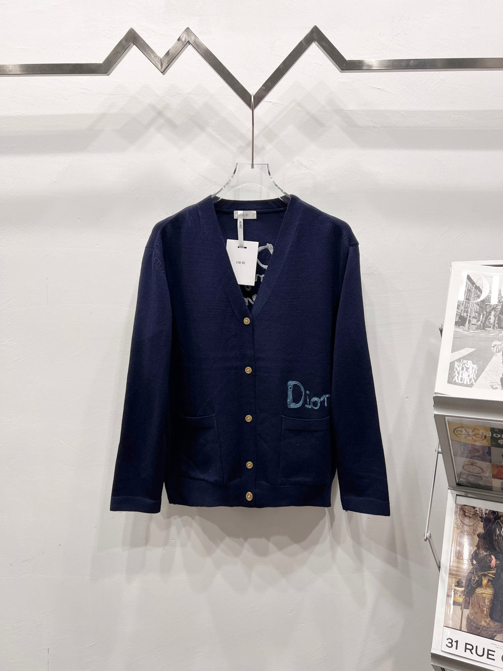 Navy V-neck cardigan with gold buttons and embroidered Dior logo on chest