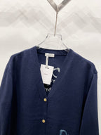 Navy V-neck cardigan with button placket and neckline label
