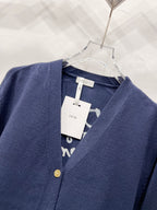 Navy V-neck cardigan with gold button details and neckline label