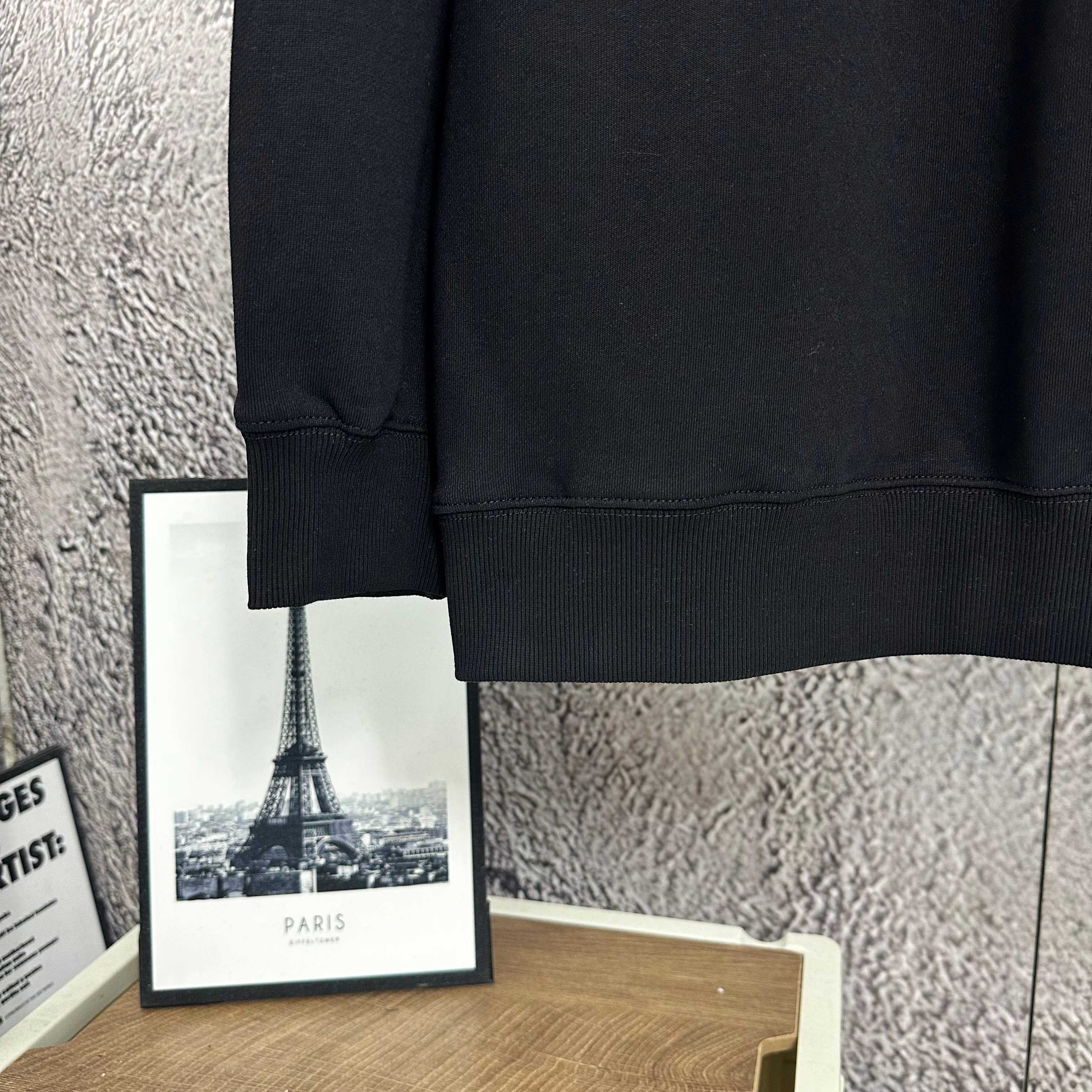 Black sweatshirt sleeve cuff and bottom hem detail