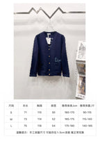 Navy V-neck cardigan on hanger with size chart measurements table