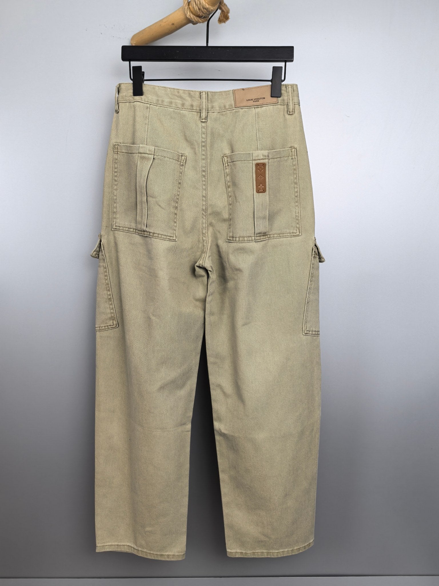 Beige denim cargo pants with back pockets and square logo patch detail